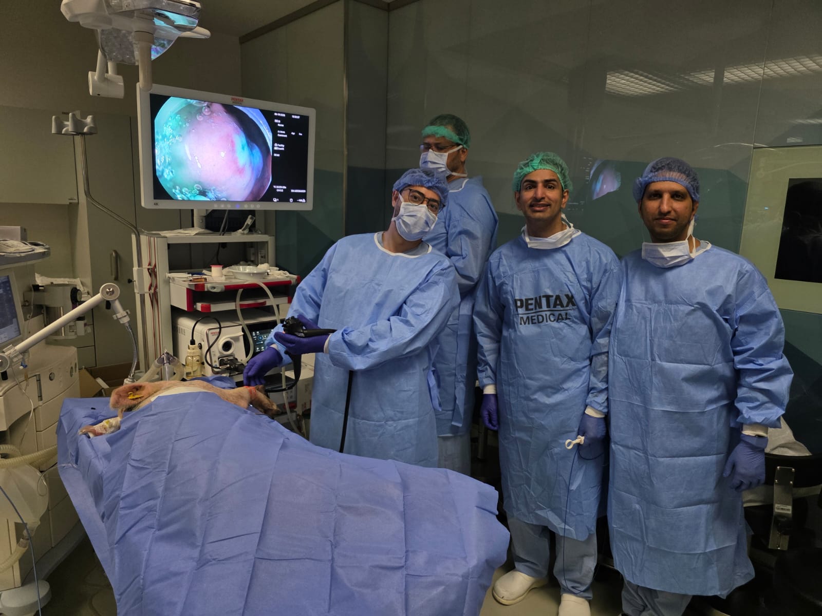 Live endoscopic procedure broadcast on a 4K monitor.